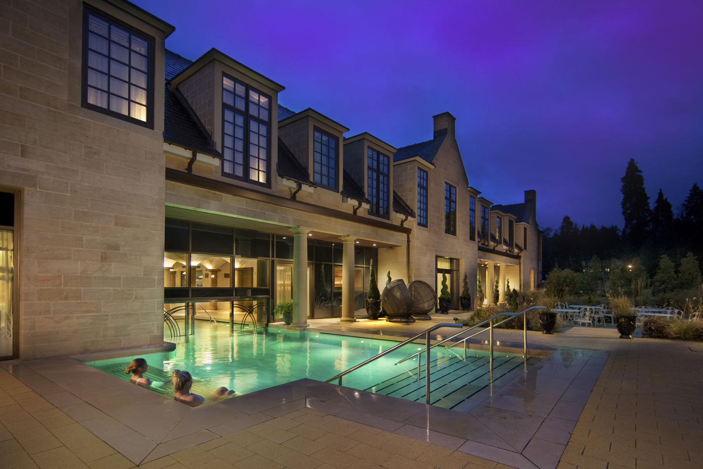 The Three Graces Spa outdoor pool at Grantley Hall at twilight